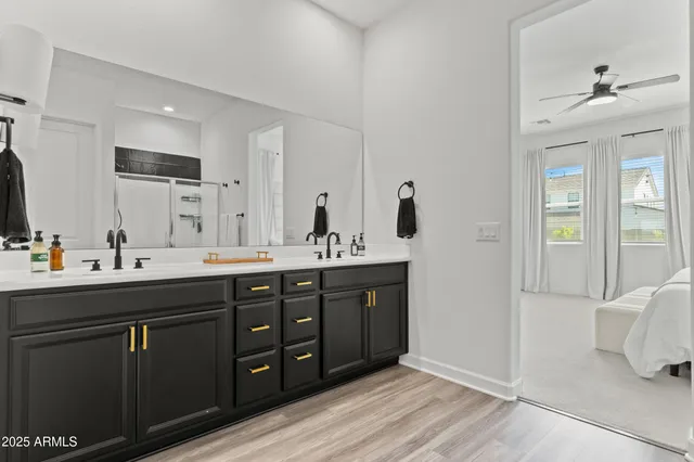 a en suite bathroom with a double vanity sink and a mirror