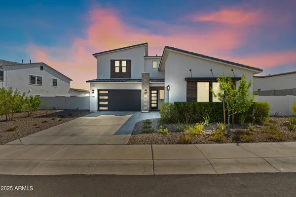 a front view of a house with a yard and a garage