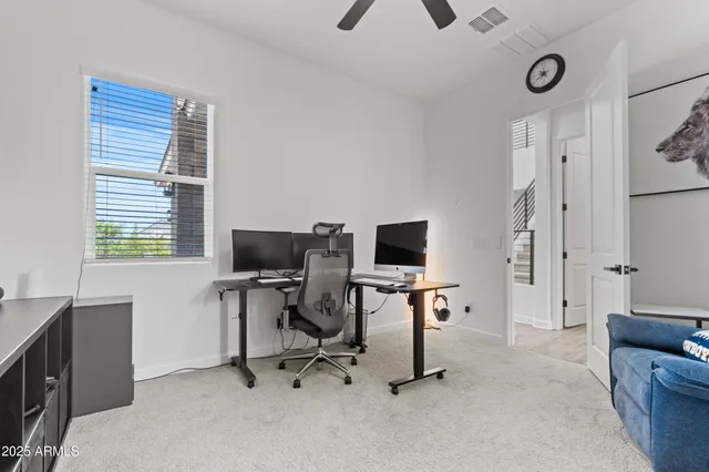 a view of a livingroom with workspace and a window
