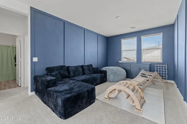 a living room with couches and large window