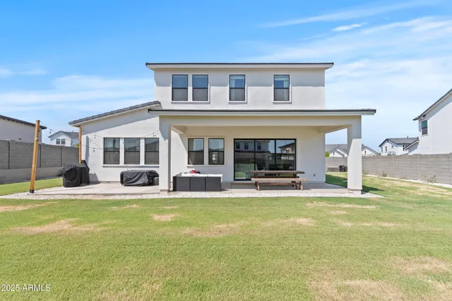 a view of a house with pool and a yard
