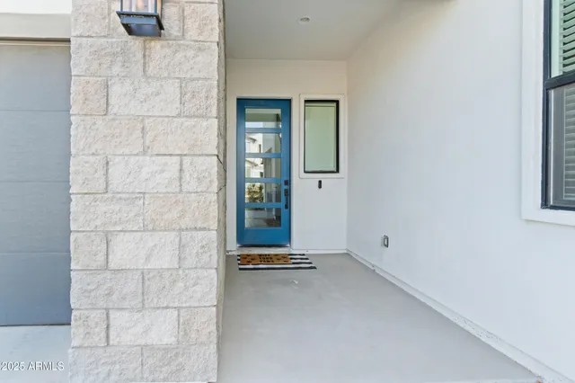 a view of a livingroom with a white wall and a window