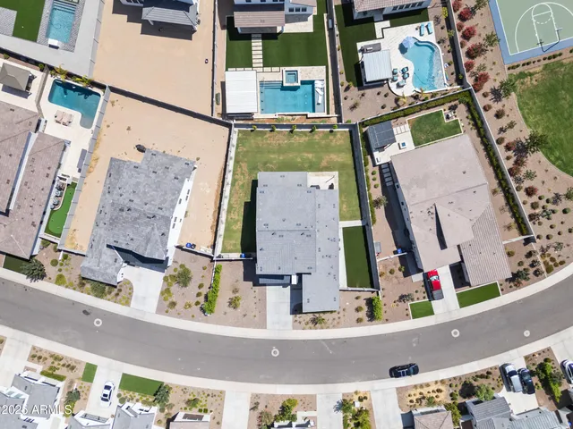 an aerial view of houses with cars