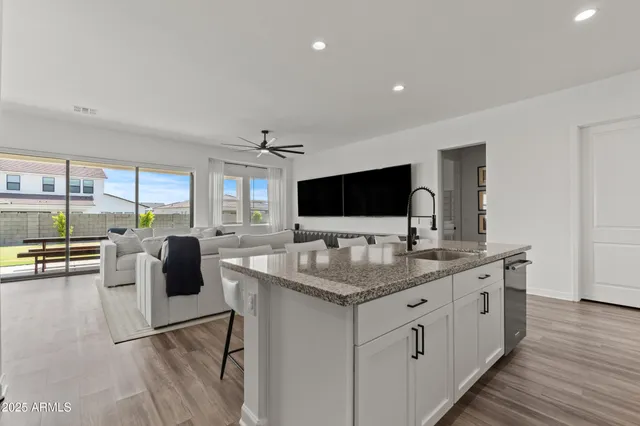 a kitchen with stainless steel appliances granite countertop a sink and a stove