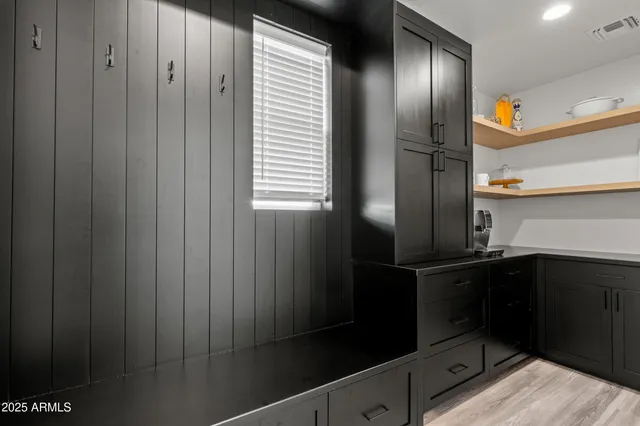 a kitchen with a refrigerator and cabinets