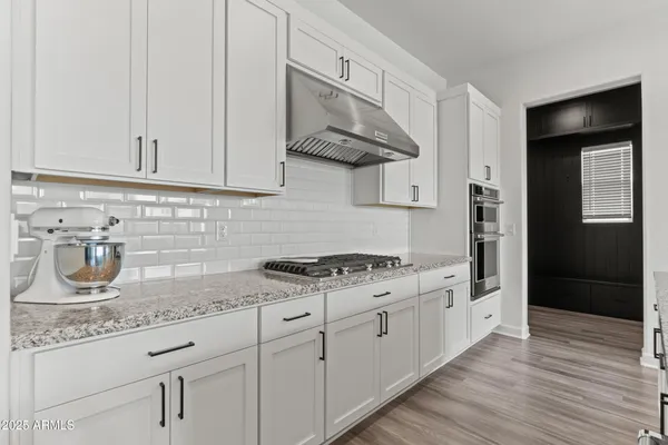 a kitchen with stainless steel appliances granite countertop a sink and a stove