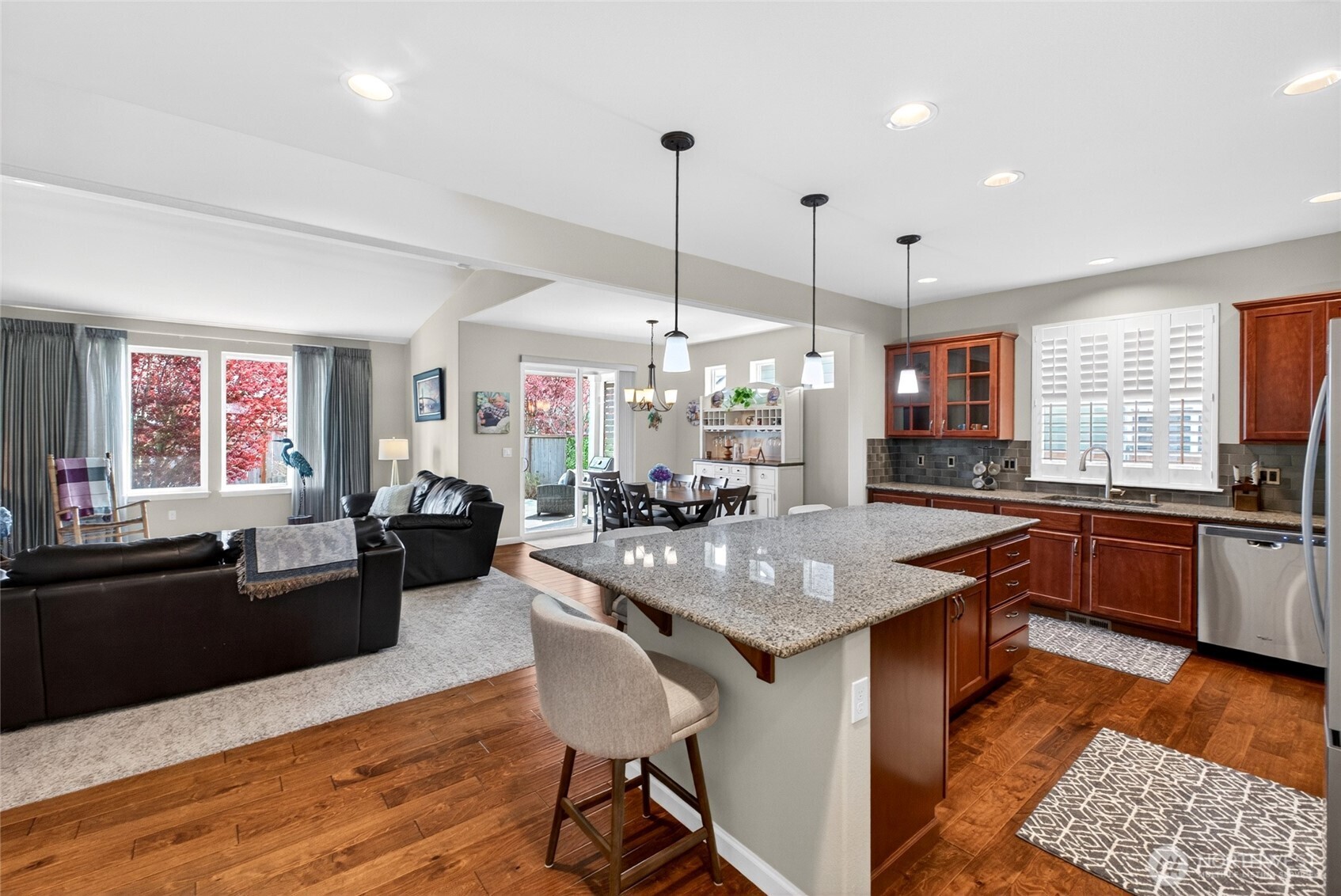 646 Mandee Street Southeast Lacey, WA 98513 - Photo 11 of 39 a kitchen with granite countertop a stove a sink a dining table and chairs