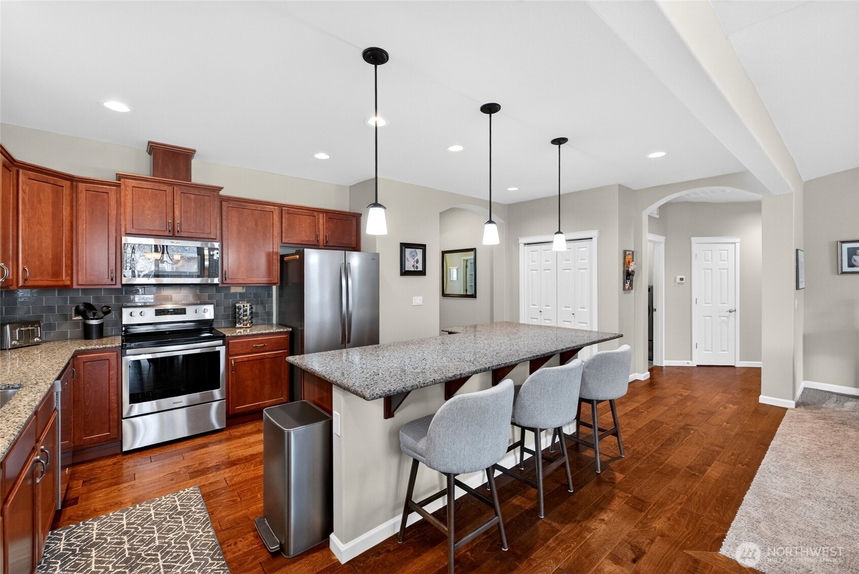 646 Mandee Street Southeast Lacey, WA 98513 - Photo 13 of 39 a kitchen with stainless steel appliances kitchen island granite countertop a table chairs sink and stove top oven