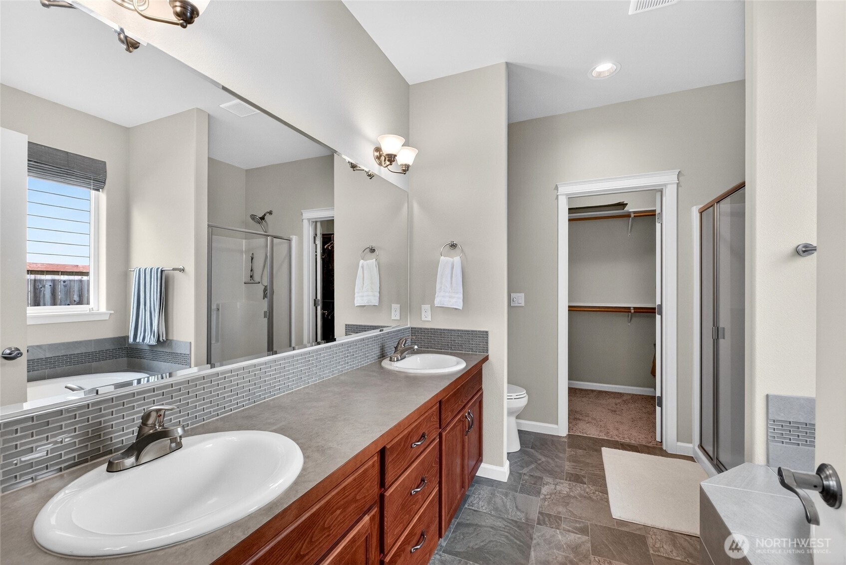 646 Mandee Street Southeast Lacey, WA 98513 - Photo 23 of 39 a bathroom with a granite countertop sink a mirror and a shower