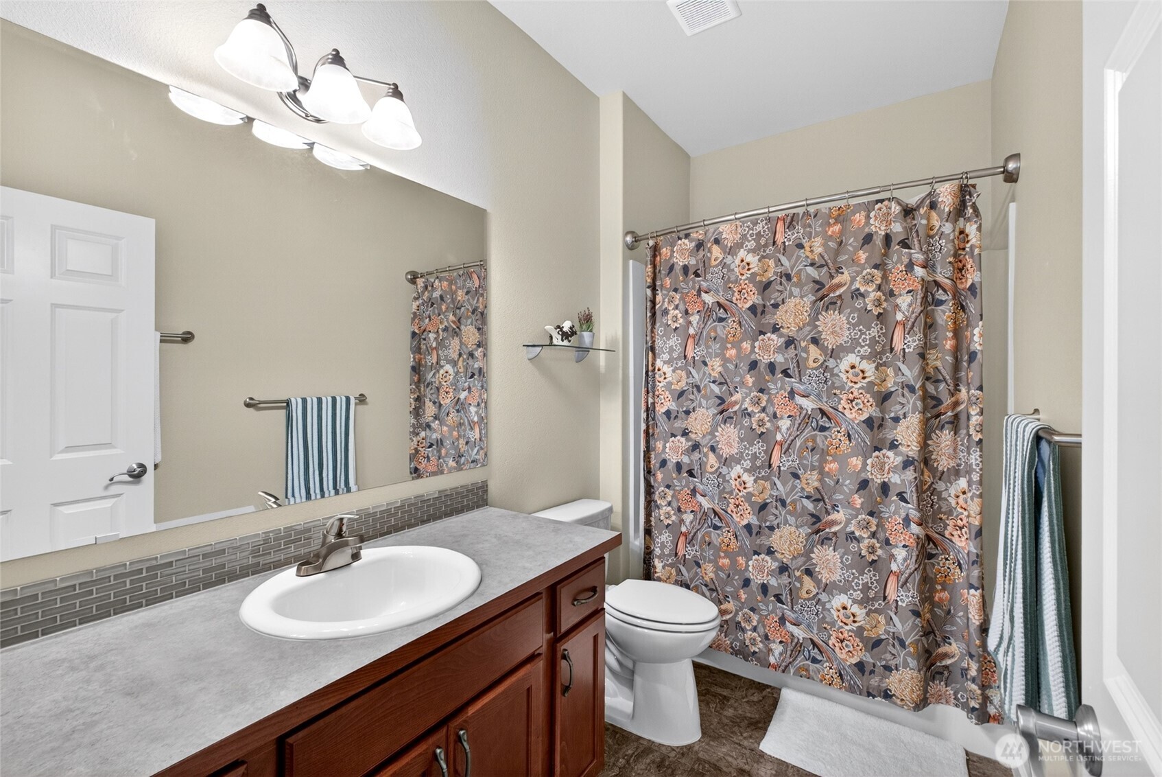 646 Mandee Street Southeast Lacey, WA 98513 - Photo 9 of 39 a bathroom with a toilet a sink and a mirror