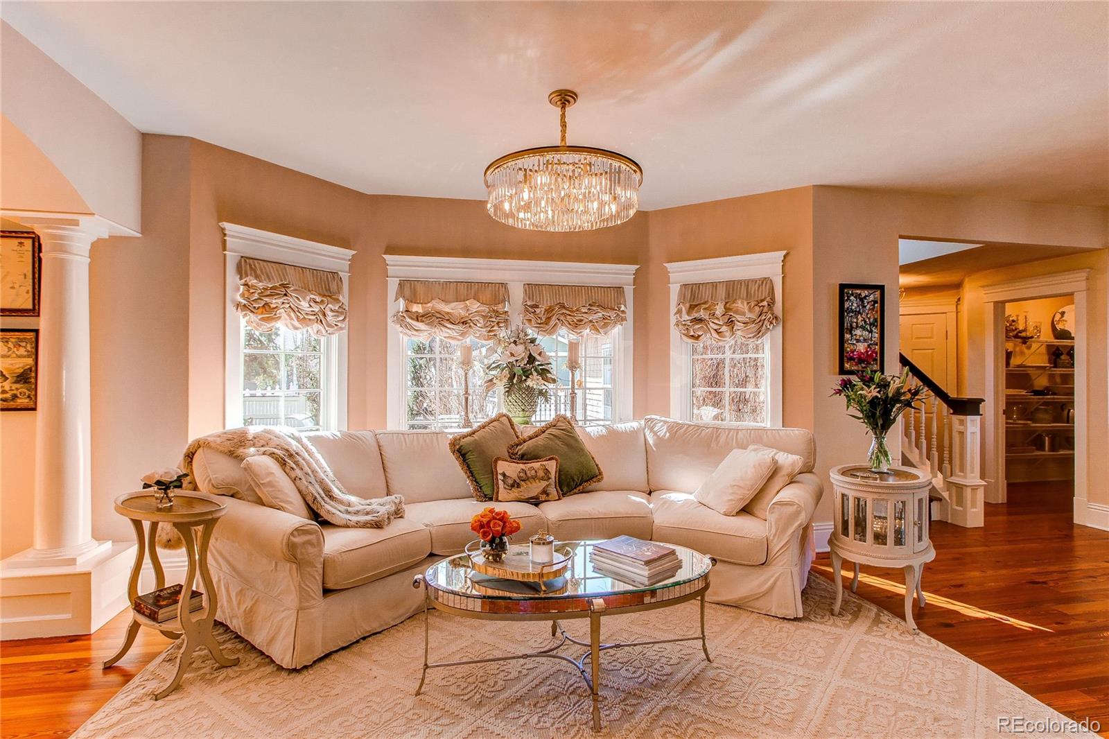 1135 Founders Circle Windsor, CO 80550 - Photo 14 of 45 a living room with furniture chandelier and a large window