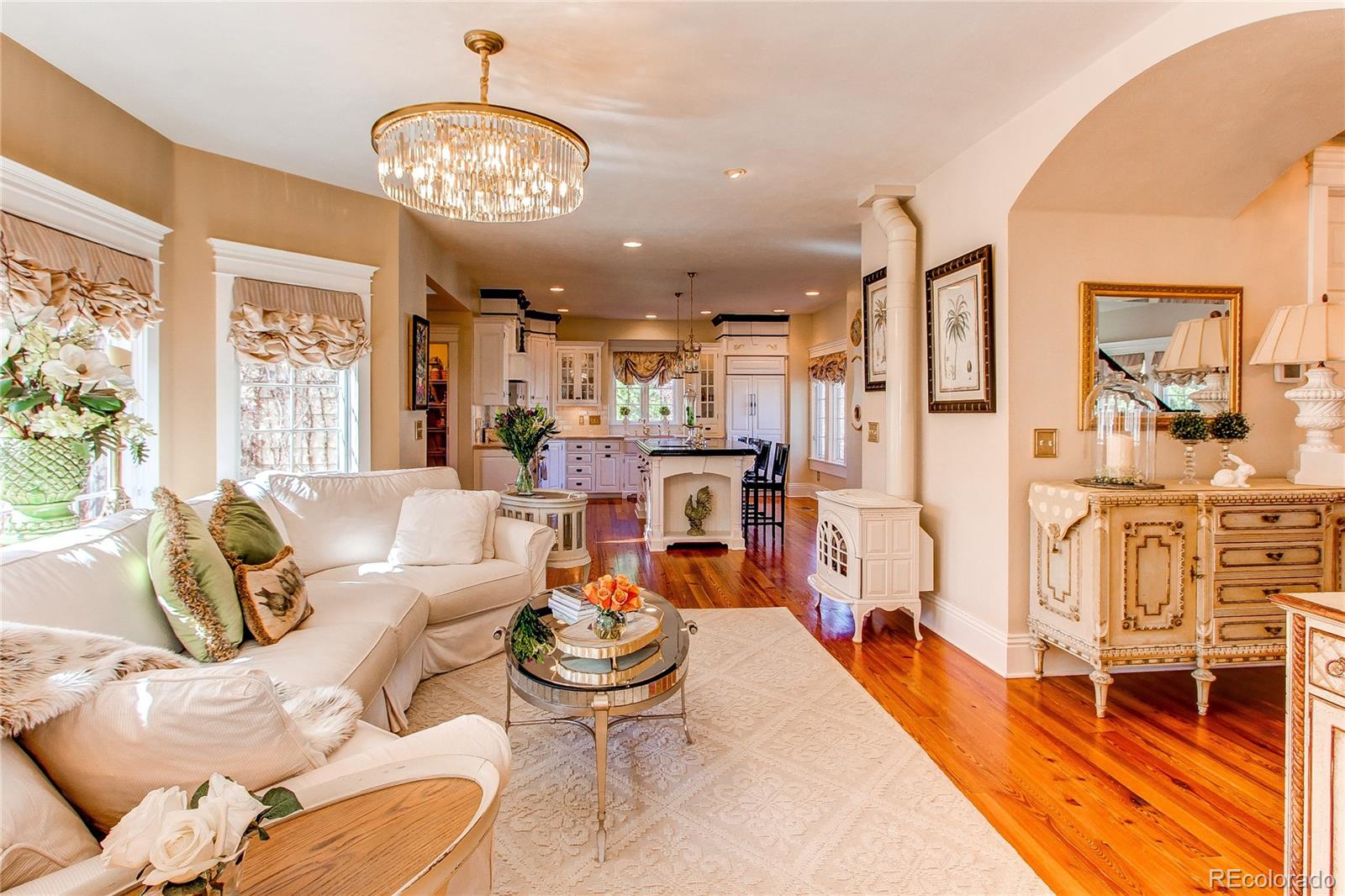 1135 Founders Circle Windsor, CO 80550 - Photo 15 of 45 a living room with lots of furniture and a large mirror next to a window
