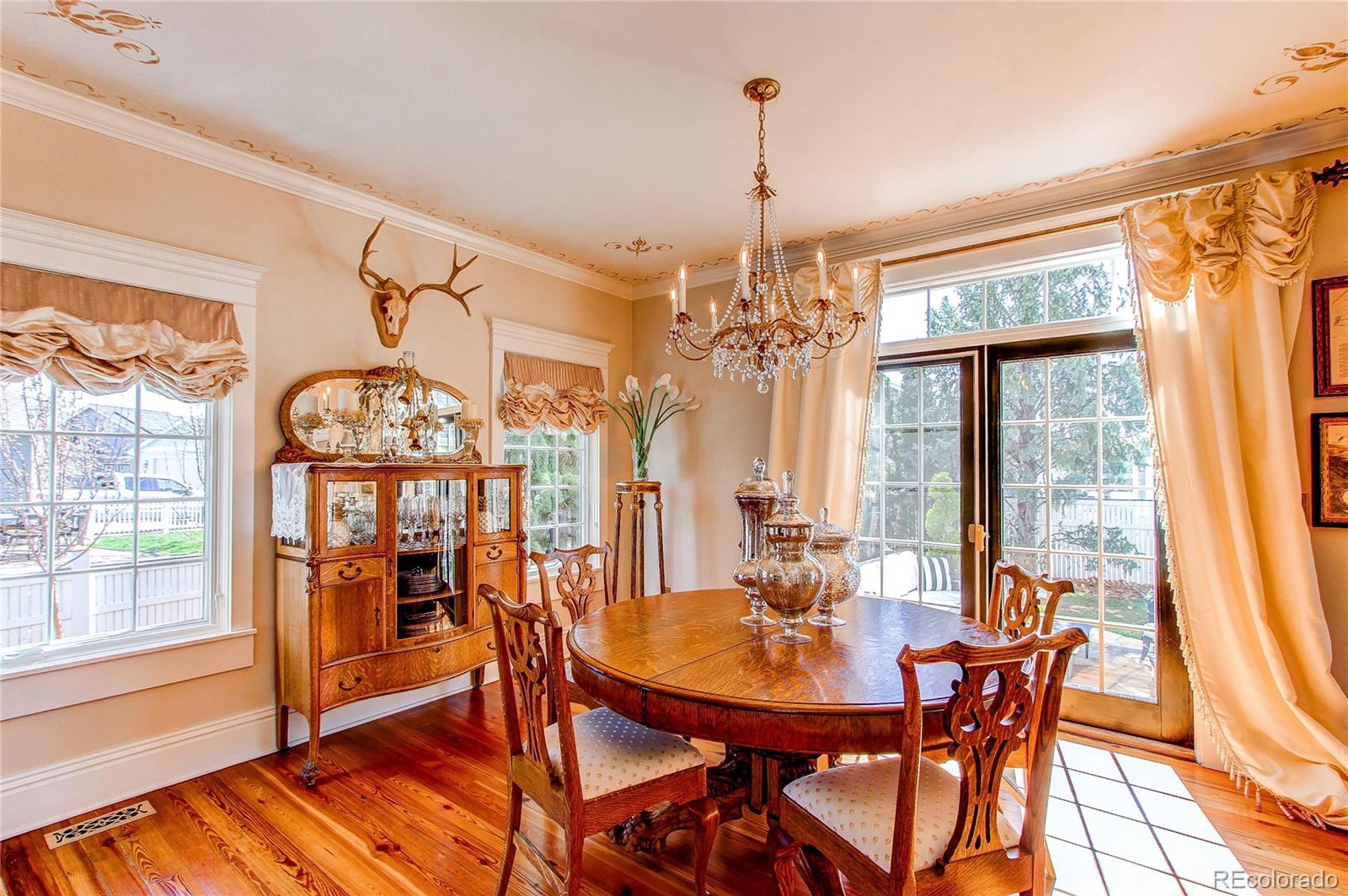 1135 Founders Circle Windsor, CO 80550 - Photo 16 of 45 a view of a dining room with furniture window and wooden floor