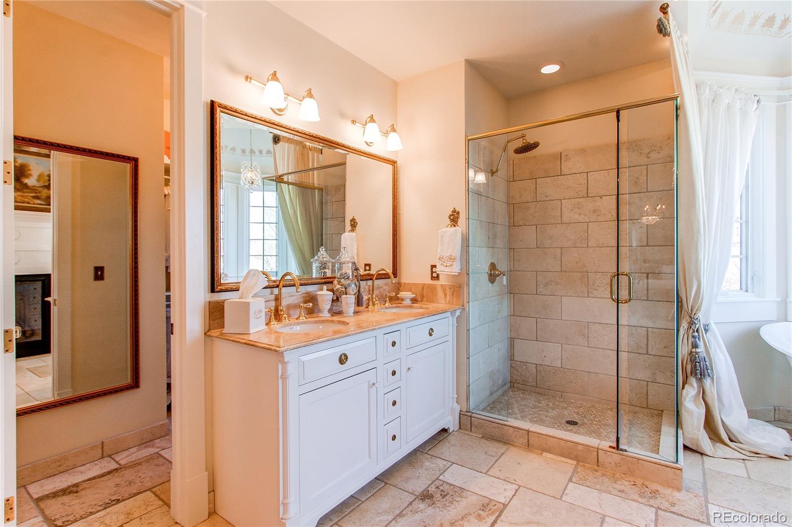 1135 Founders Circle Windsor, CO 80550 - Photo 22 of 45 a bathroom with a shower sink and mirror