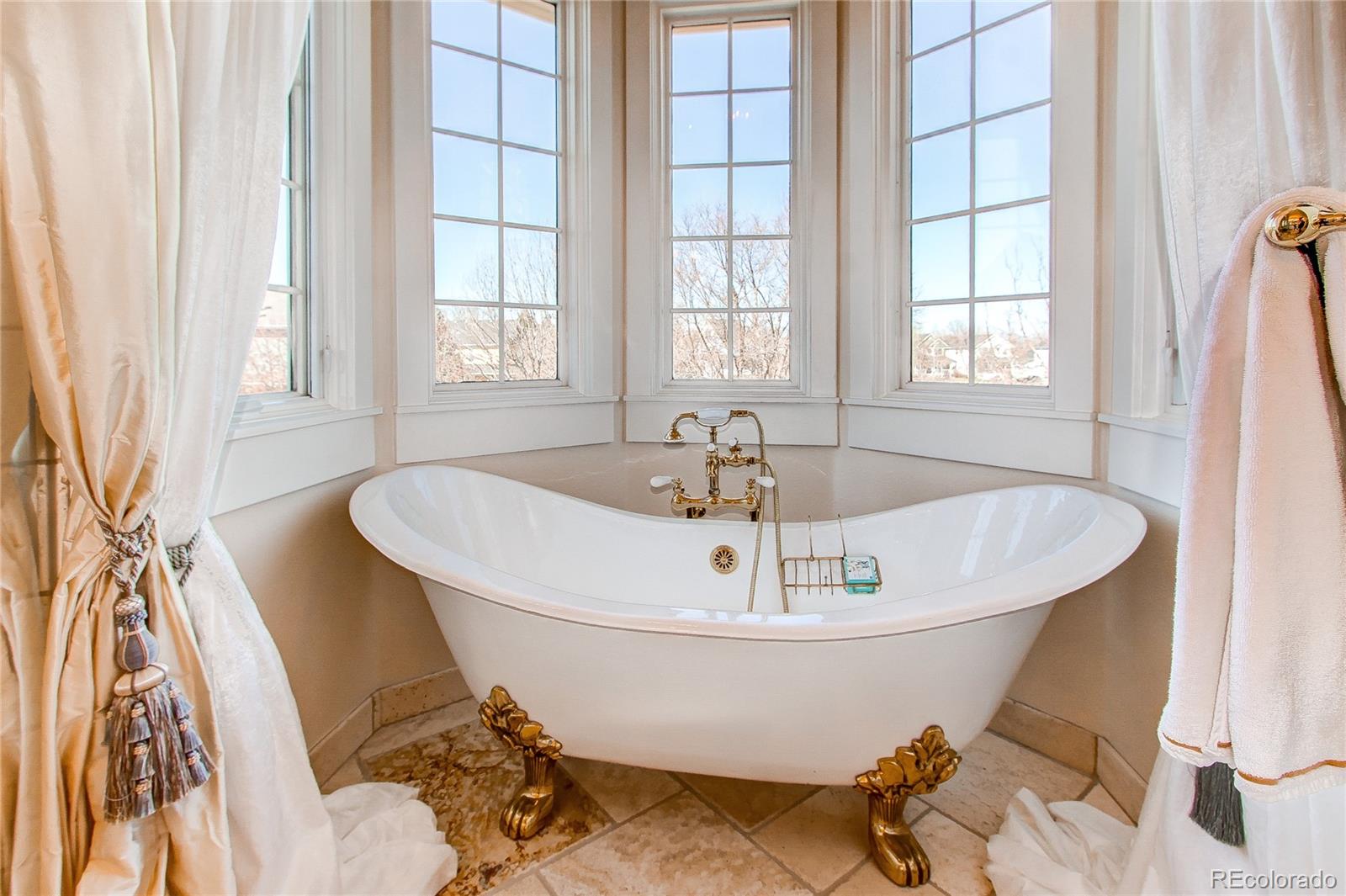 1135 Founders Circle Windsor, CO 80550 - Photo 23 of 45 a white bath tub sitting in a bathroom next to a window