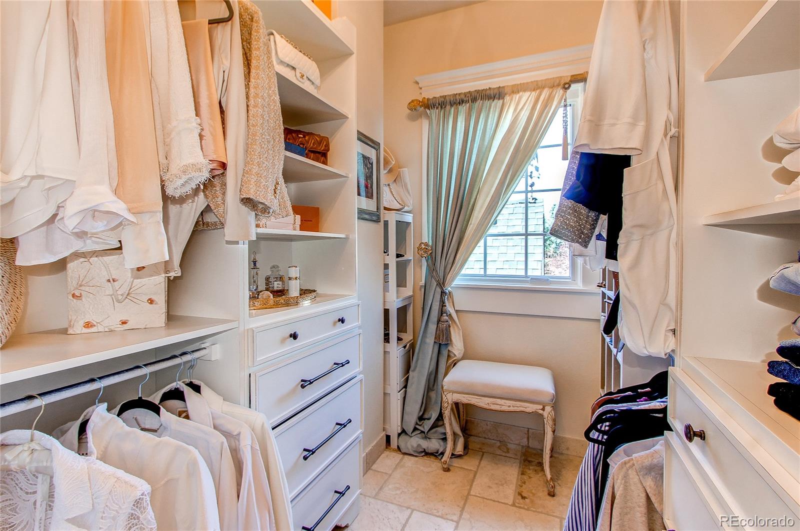 1135 Founders Circle Windsor, CO 80550 - Photo 24 of 45 a view of walk in closet with clothes and shoes