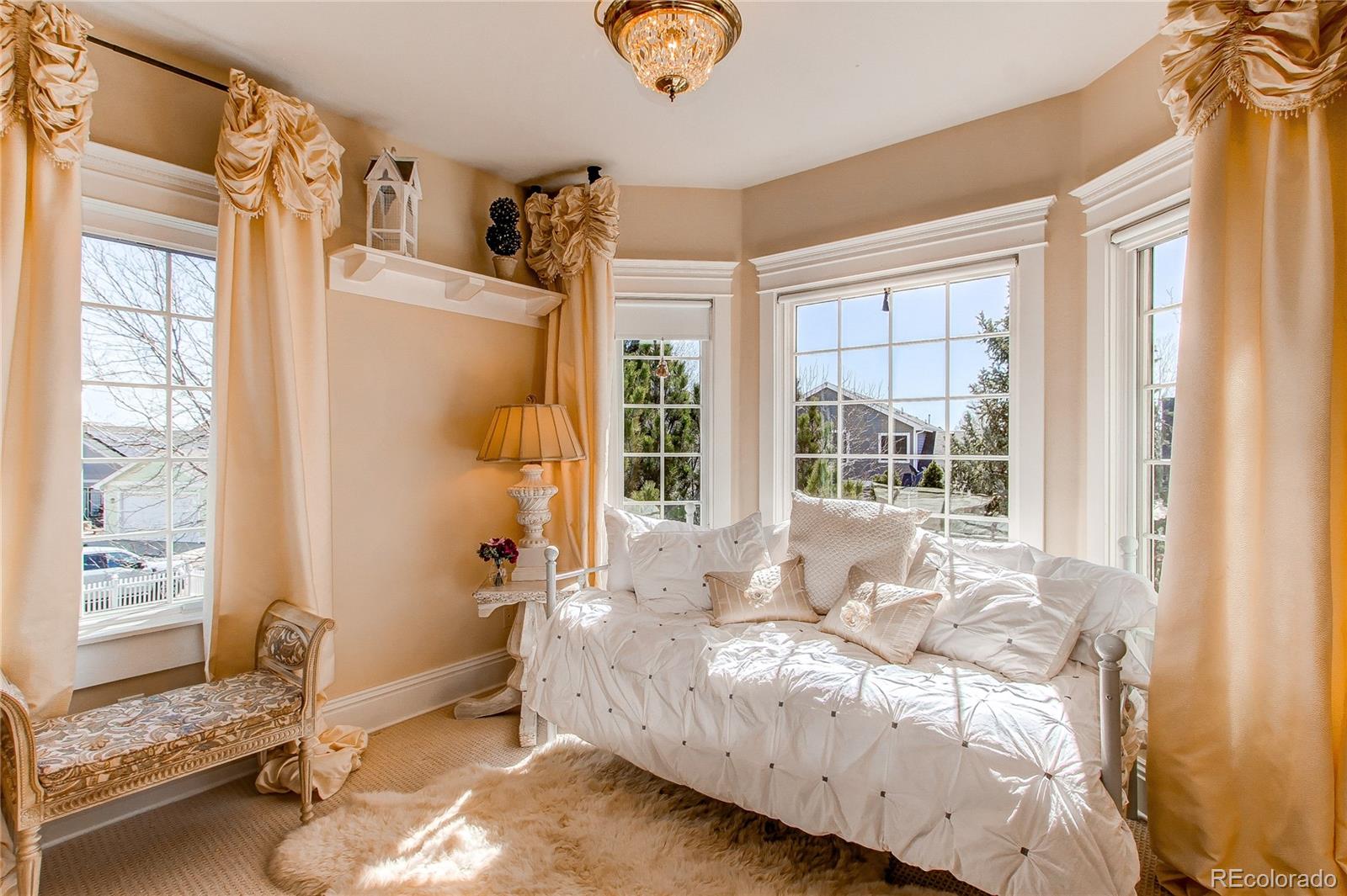 1135 Founders Circle Windsor, CO 80550 - Photo 25 of 45 a bed sitting in a bedroom next to a window