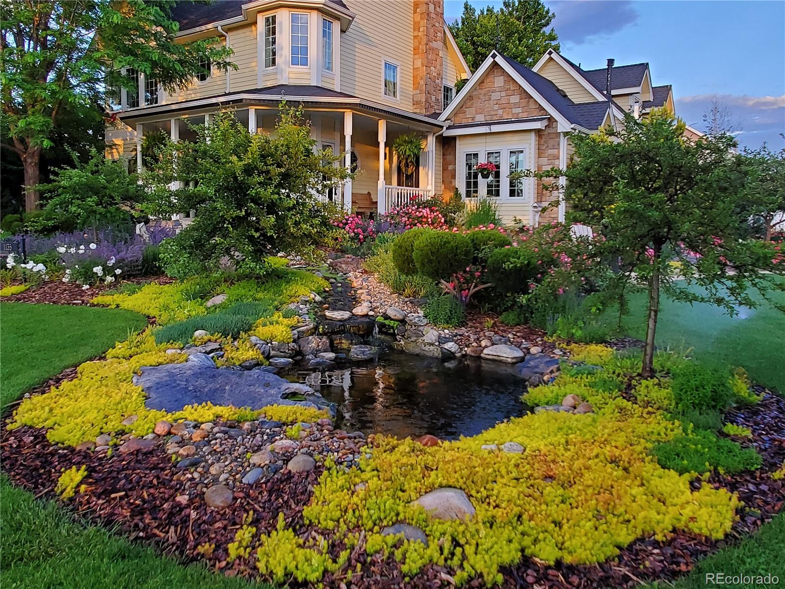 1135 Founders Circle Windsor, CO 80550 - Photo 3 of 45 a view of a house with a yard and garden