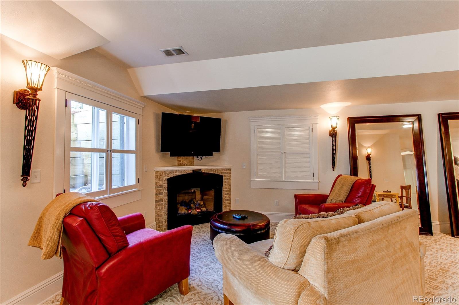 1135 Founders Circle Windsor, CO 80550 - Photo 33 of 45 a living room with furniture flat screen tv and a fireplace