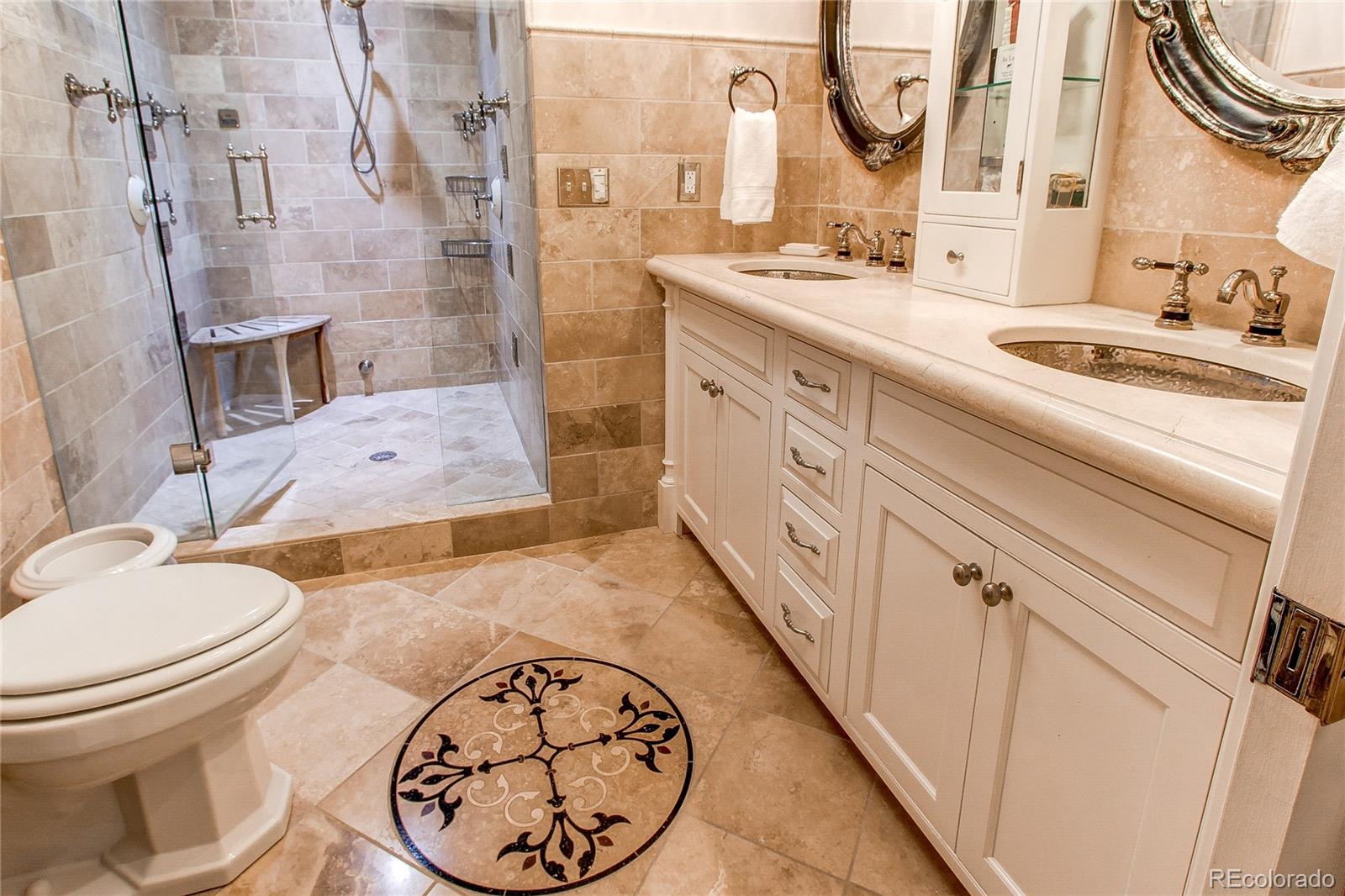1135 Founders Circle Windsor, CO 80550 - Photo 37 of 45 a bathroom with a granite countertop sink mirror vanity and toilet