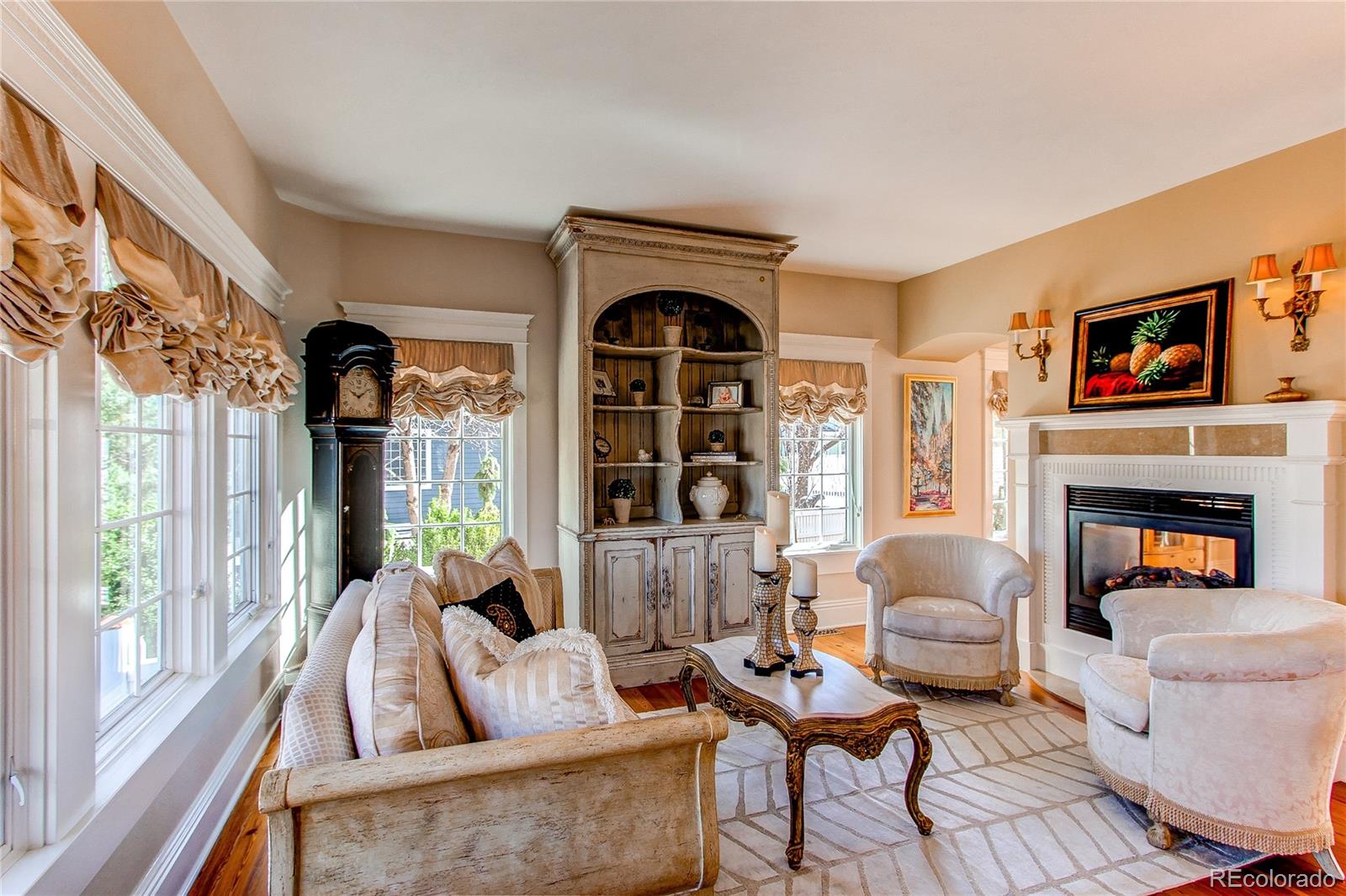 1135 Founders Circle Windsor, CO 80550 - Photo 5 of 45 a living room with furniture a fireplace and a large window