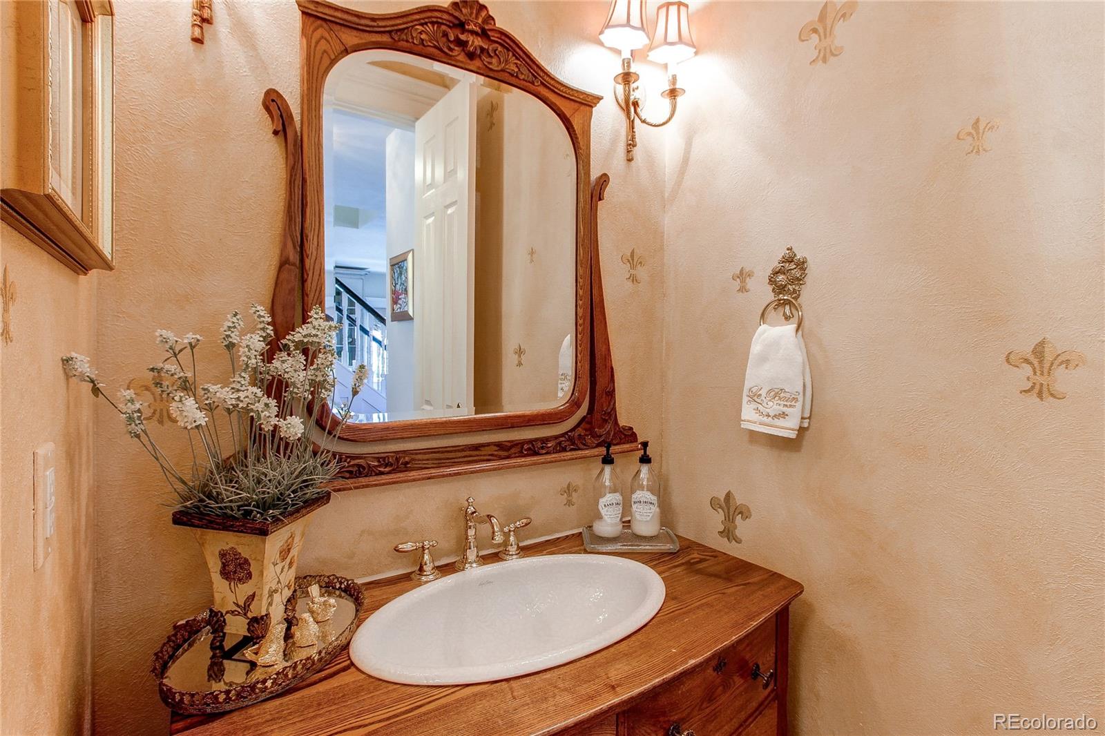 1135 Founders Circle Windsor, CO 80550 - Photo 8 of 45 a bathroom with a sink and a mirror