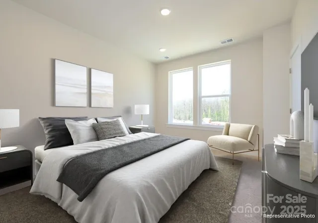 a bedroom with bed and a large window