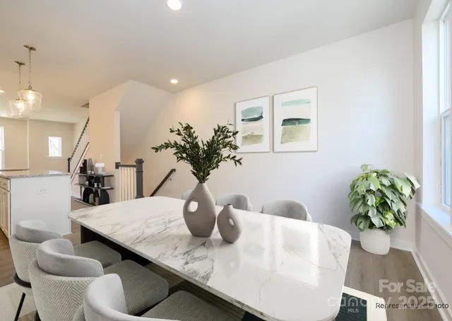 a dining room with furniture and wooden floor