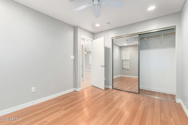 a view of empty room with wooden floor