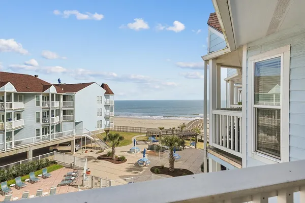 a view of a swimming pool with outdoor seating