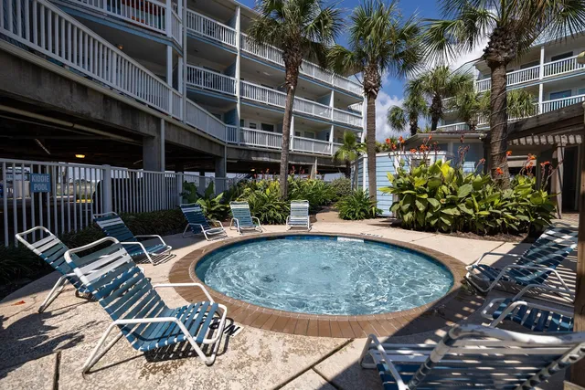 a view of a patio with dining table and chairs