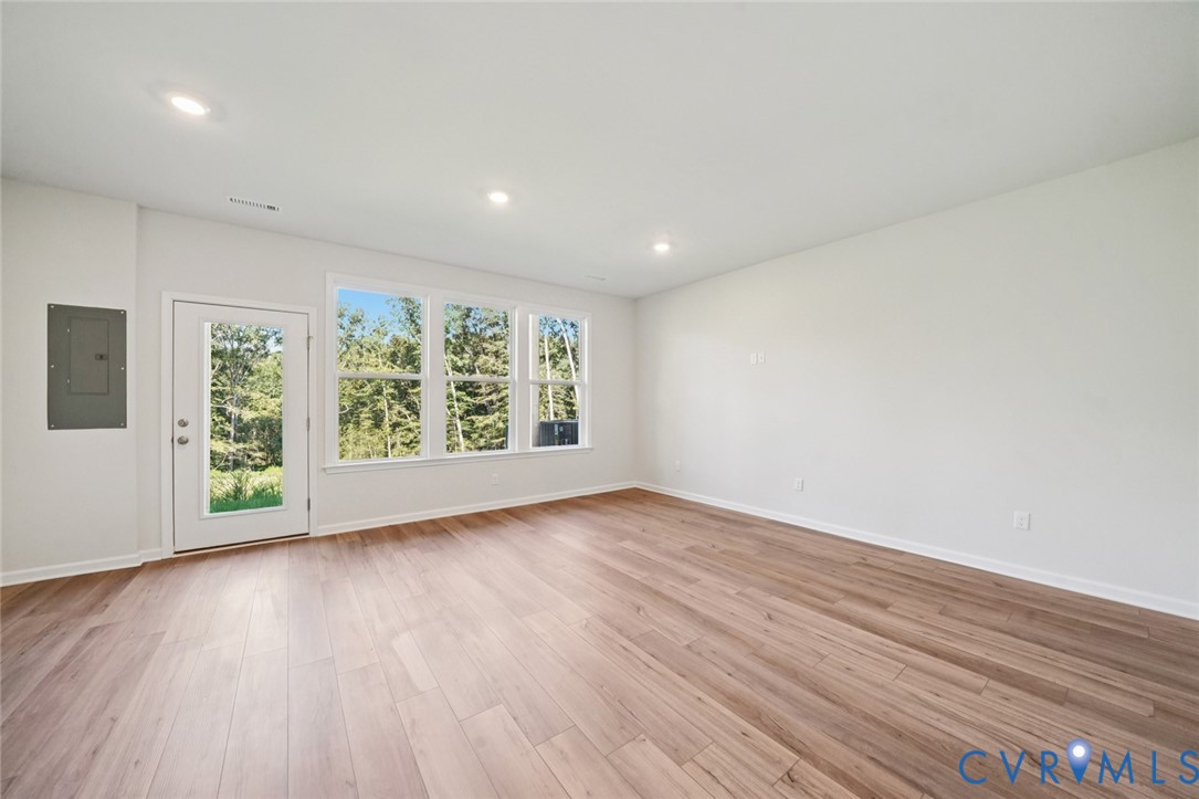346 Mt Mccauley Way Aylett, VA 23009 - Photo 17 of 32 an empty room with wooden floor and windows