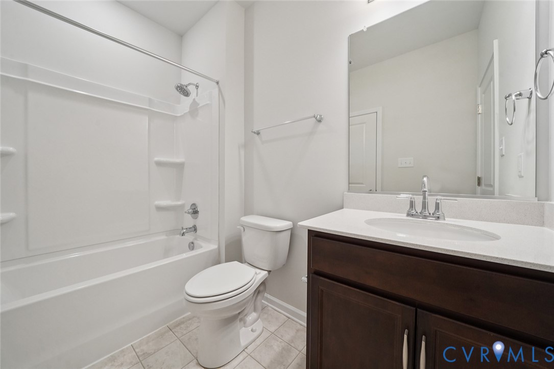 346 Mt Mccauley Way Aylett, VA 23009 - Photo 19 of 32 a bathroom with a sink a toilet and a mirror
