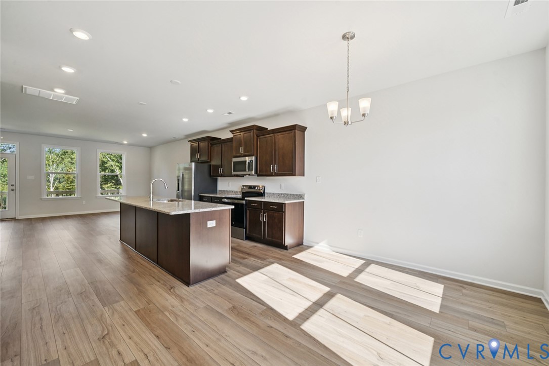346 Mt Mccauley Way Aylett, VA 23009 - Photo 2 of 32 a kitchen with stainless steel appliances granite countertop a stove a sink and a refrigerator