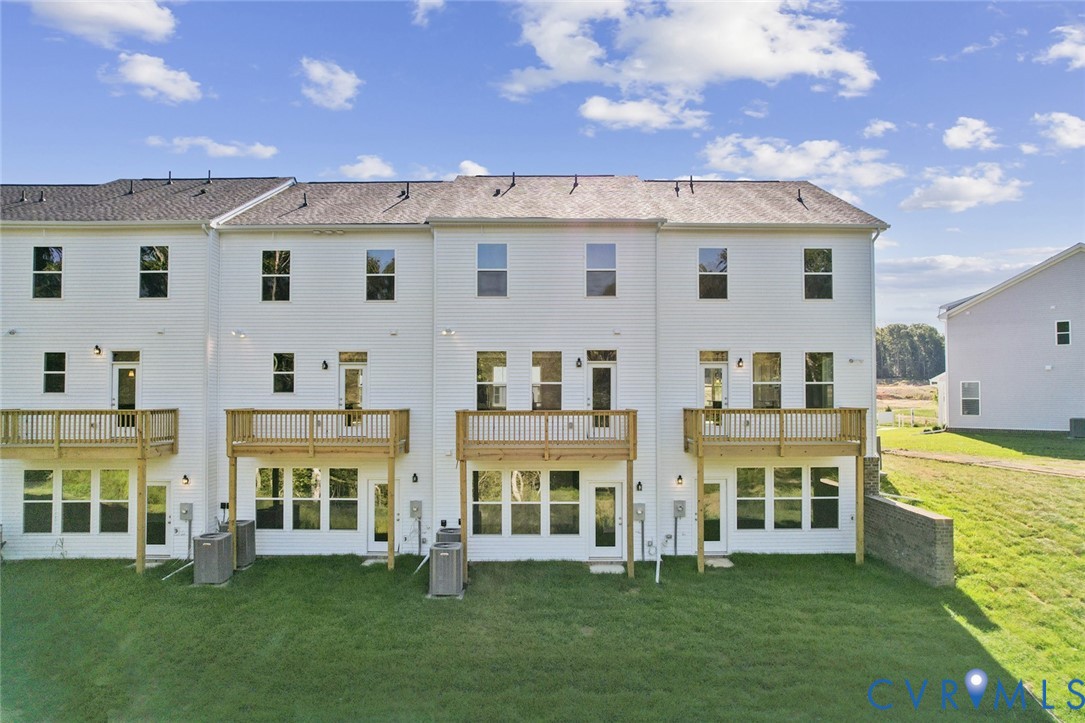 346 Mt Mccauley Way Aylett, VA 23009 - Photo 32 of 32 front view of a white building with a yard and plants