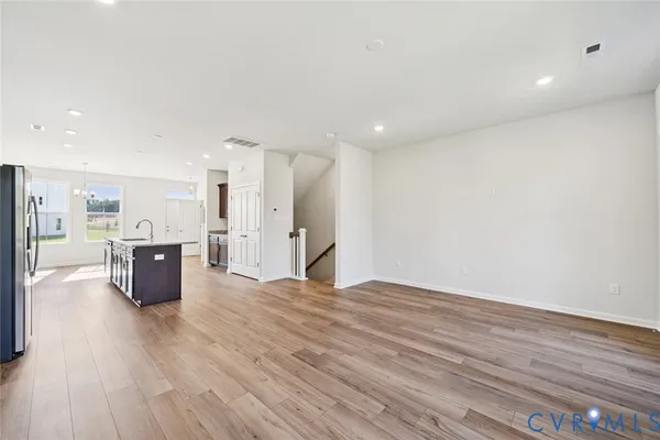 a view of kitchen with kitchen island wooden floor and center island