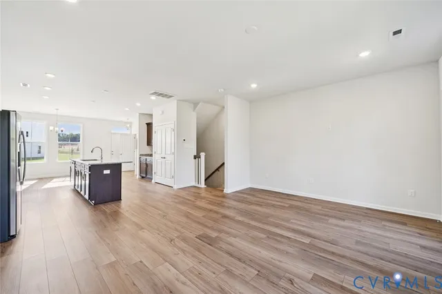 a view of kitchen with kitchen island wooden floor and center island