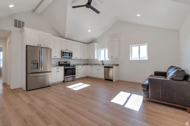 1820 West Farmhouse Flats Road Peoa, UT 84061 - Photo 49 of 79 Open-concept living space featuring a vaulted ceiling and wood-finish flooring