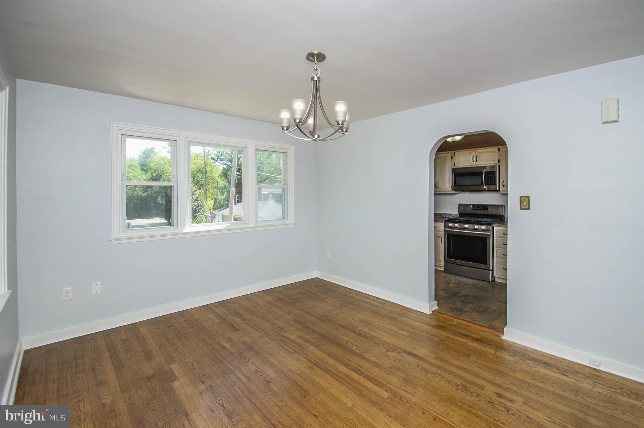201 Sycamore Road Reading, PA 19611 - Photo 5 of 13 a view of empty room with wooden floor chandelier and windows