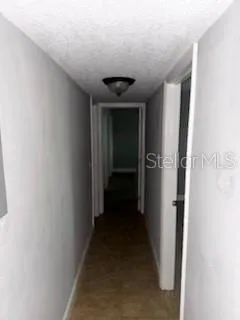 a view of a hallway with a room