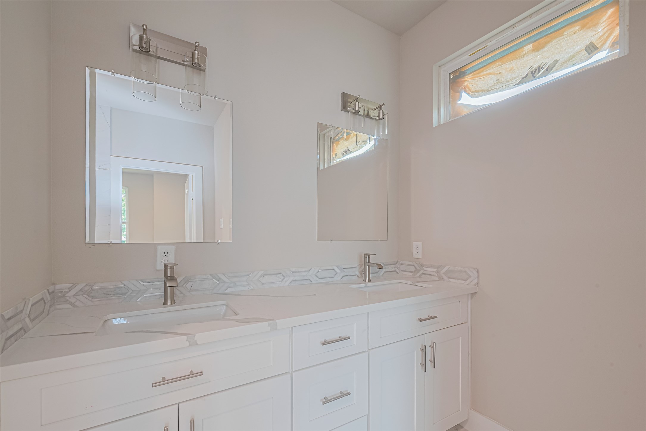 7207 Force Street Houston, TX 77020 - Photo 15 of 29 A double vanity featuring white cabinetry and sleek fixtures.