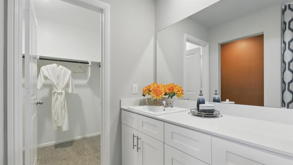 336 Pecos Drive Azle, TX 76020 - Photo 18 of 37 a bathroom with a sink vanity and a mirror