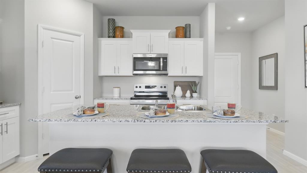 336 Pecos Drive Azle, TX 76020 - Photo 35 of 37 a kitchen with stainless steel appliances granite countertop a stove a sink and a refrigerator