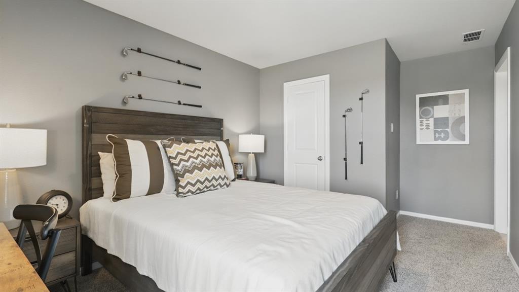 336 Pecos Drive Azle, TX 76020 - Photo 33 of 37 a bedroom with a bed and a chandelier