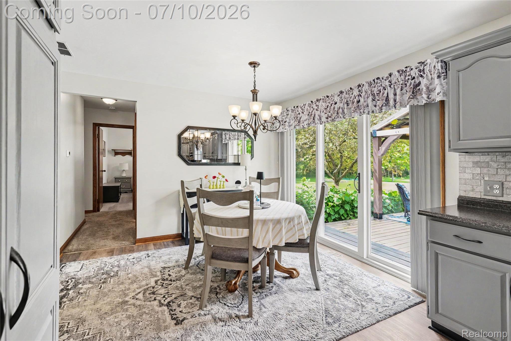 2180 Hurst Road St. Clair, MI 48079 - Photo 13 of 39 Dining area featuring a chandelier, a sliding glass door to the exterior, and wood-finish flooring