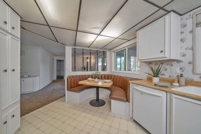 a living room with granite countertop furniture and a potted plant