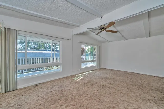 a kitchen with granite countertop a refrigerator and a stove top oven