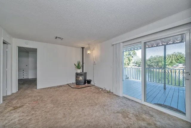 a large bathroom with a granite countertop sink a window and a mirror