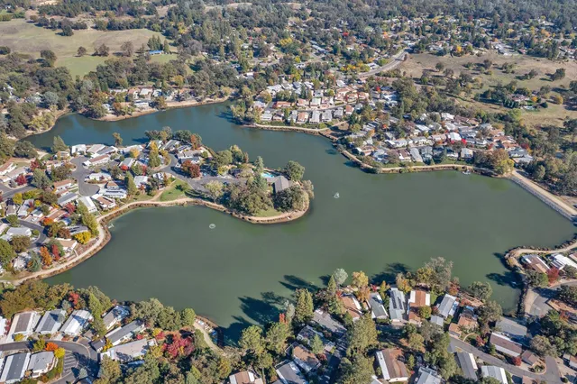 an aerial view of a house with a lake view