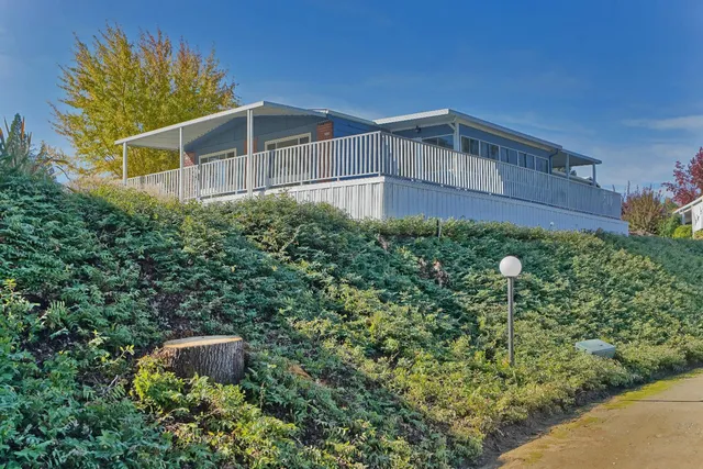 a front view of a house with a yard and fountain